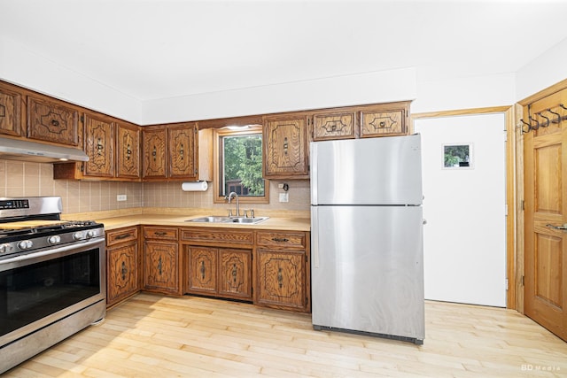 7043 W 73rd St, Nottingham Park, IL 60638 - kitchen with appliances with stainless steel finishes, under cabinet range hood, light countertops, and backsplash