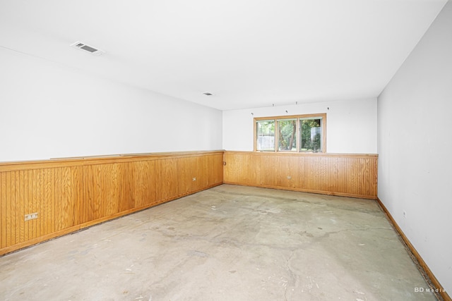 7043 W 73rd St, Nottingham Park, IL 60638 - unfurnished room with concrete flooring, wainscoting, and wooden walls