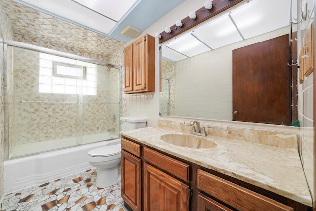 7830 S Kolmar Ave, Chicago, IL 60652 - bathroom with toilet, vanity, combined bath / shower with glass door, and tile walls
