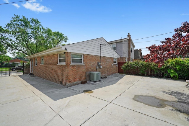 7830 S Kolmar Ave, Chicago, IL 60652 - view of property exterior featuring a patio area, brick siding, and cooling unit