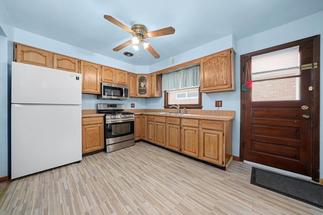 7830 S Kolmar Ave, Chicago, IL 60652 - kitchen featuring appliances with stainless steel finishes, a sink, light countertops, a ceiling fan, and light wood finished floors