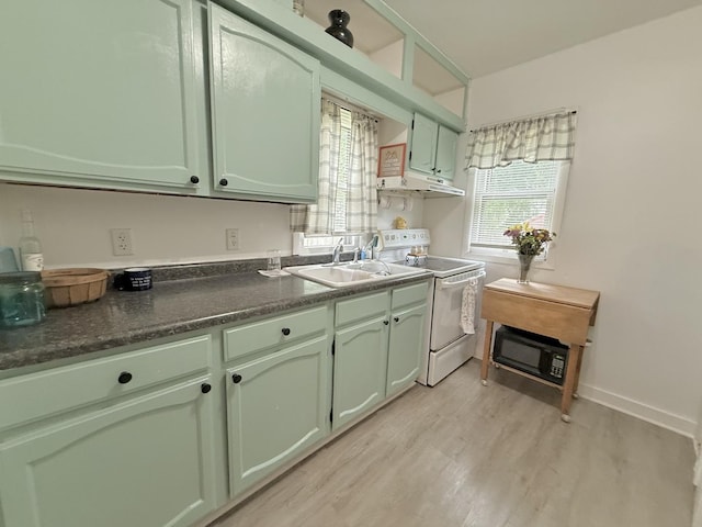 1229 W 6th St, Sterling, IL 61081 - kitchen featuring white electric stove, a sink, green cabinets, and light wood-style flooring