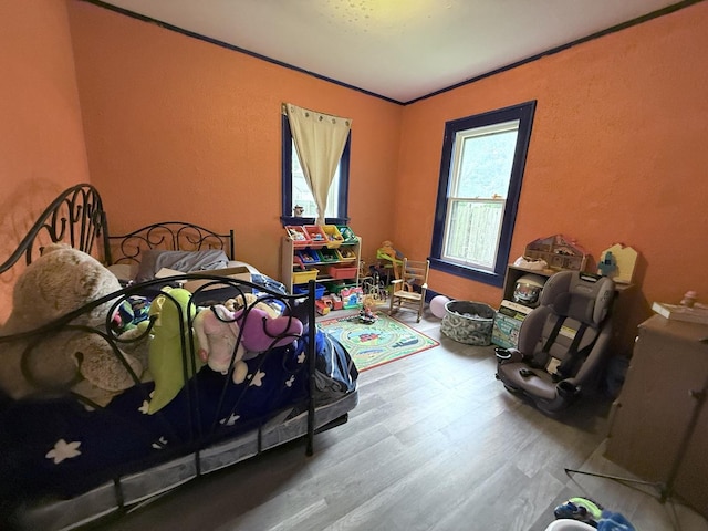 1229 W 6th St, Sterling, IL 61081 - bedroom featuring wood finished floors, crown molding, and a textured wall