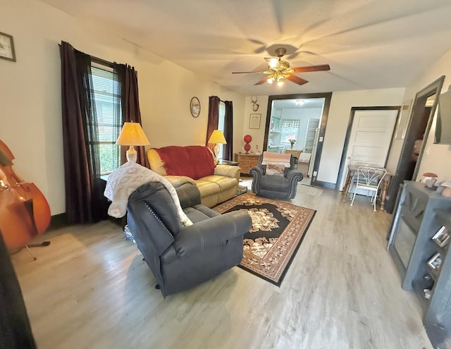 1229 W 6th St, Sterling, IL 61081 - living area featuring light wood-style floors, ceiling fan, and baseboards