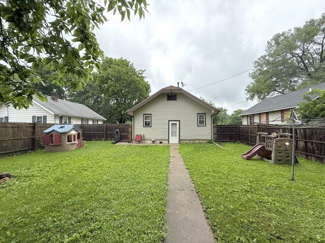 1229 W 6th St, Sterling, IL 61081 - rear view of house with a playground