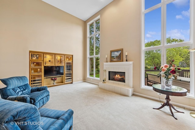 1051 Chadwick Ct, Aurora, IL 60502 - carpeted living room with high vaulted ceiling and a tiled fireplace