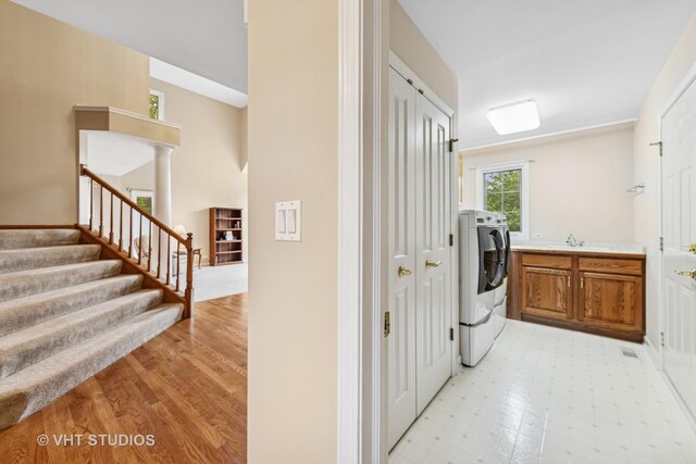 1051 Chadwick Ct, Aurora, IL 60502 - laundry area with cabinet space, washer and dryer, and light flooring