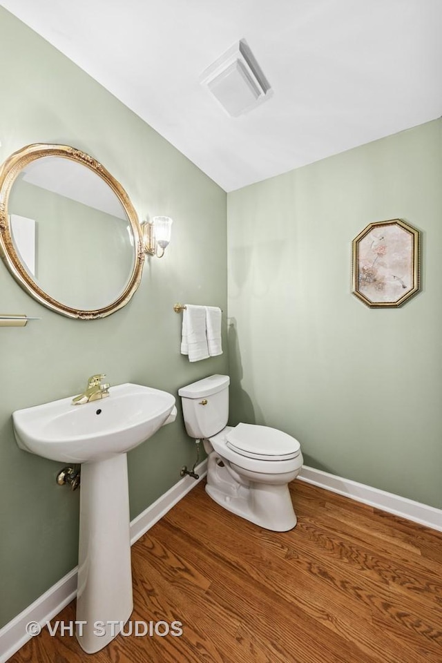 1051 Chadwick Ct, Aurora, IL 60502 - half bathroom featuring wood finished floors and lofted ceiling
