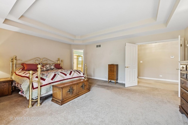 1051 Chadwick Ct, Aurora, IL 60502 - carpeted bedroom featuring a tray ceiling and baseboards