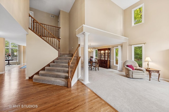 1051 Chadwick Ct, Aurora, IL 60502 - entrance foyer featuring a towering ceiling, stairs, a chandelier, and wood finished floors