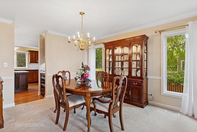 1051 Chadwick Ct, Aurora, IL 60502 - dining area with a chandelier, light carpet, healthy amount of natural light, and ornamental molding