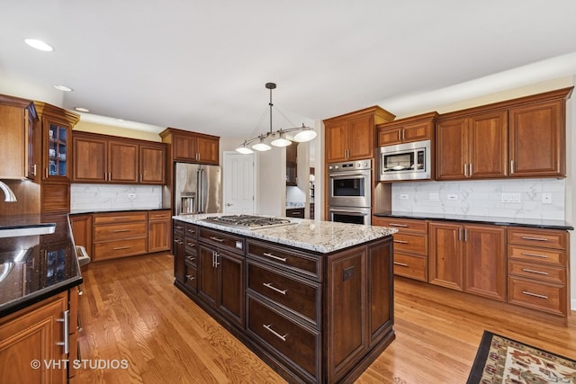 1051 Chadwick Ct, Aurora, IL 60502 - kitchen featuring stainless steel appliances, a center island, wood finished floors, backsplash, and recessed lighting