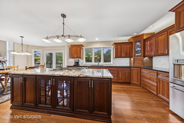 1051 Chadwick Ct, Aurora, IL 60502 - kitchen featuring appliances with stainless steel finishes, dark wood-style floors, a center island, decorative light fixtures, and recessed lighting