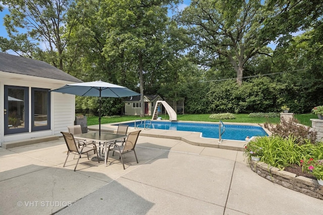 0S706 Madison St, Winfield, IL 60190 - outdoor pool with a water slide, an outdoor structure, a patio area, outdoor dining space, and view of wooded area