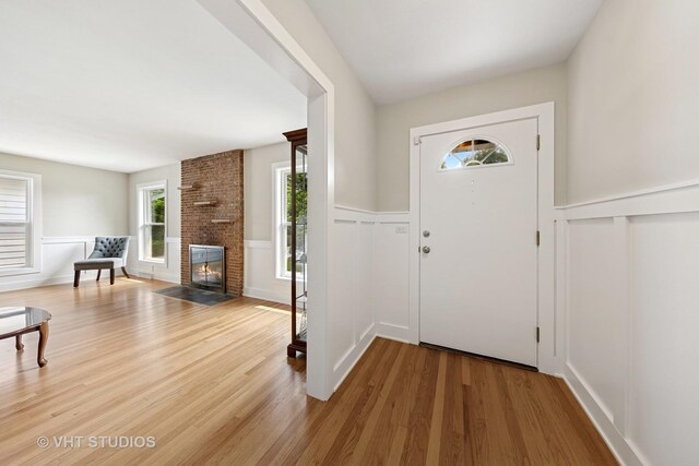 0S706 Madison St, Winfield, IL 60190 - foyer featuring wood finished floors, wainscoting, a fireplace, and a decorative wall