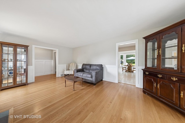 0S706 Madison St, Winfield, IL 60190 - living area with a wainscoted wall, light wood-style floors, and a decorative wall