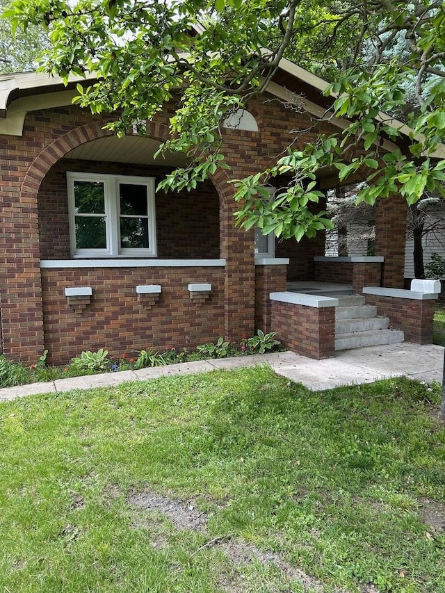 904 Johnson St, Streator, IL 61364 - view of home's exterior featuring brick siding and a lawn