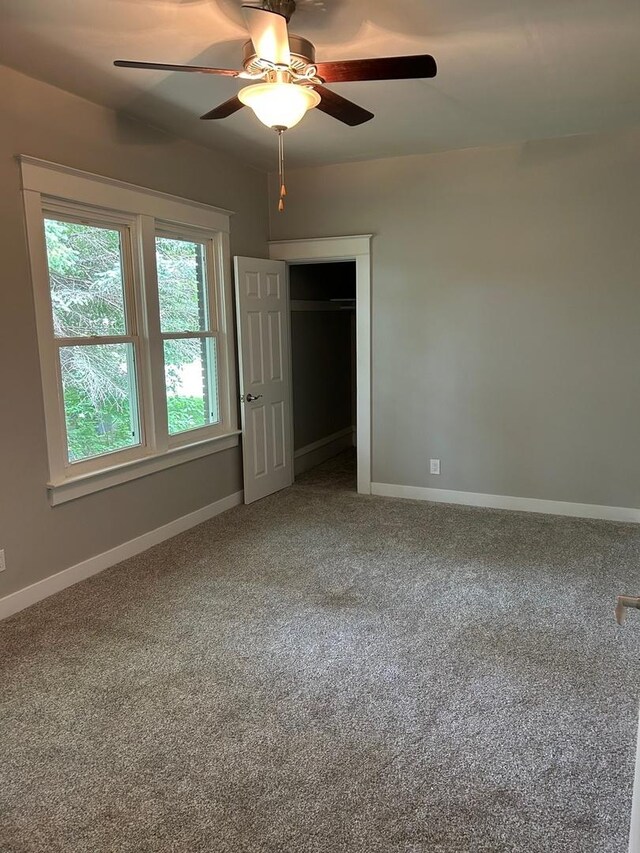 904 Johnson St, Streator, IL 61364 - unfurnished bedroom with carpet, baseboards, a closet, and ceiling fan