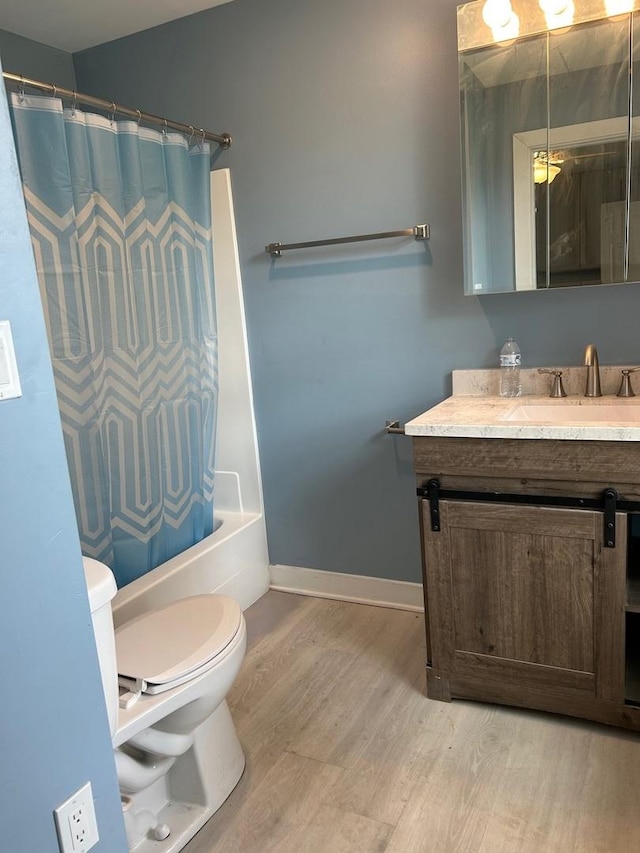 904 Johnson St, Streator, IL 61364 - bathroom with toilet, wood finished floors, vanity, shower / bath combination with curtain, and baseboards