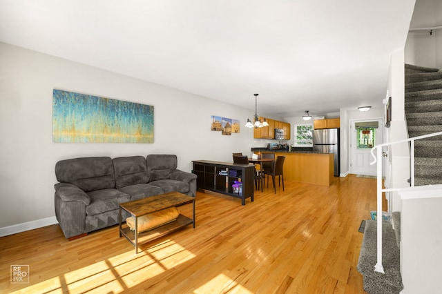525 W Washington Ave Unit 6, Lake Bluff, IL 60044 - living room with stairway, a chandelier, and light wood-type flooring