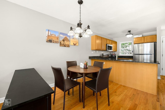 525 W Washington Ave Unit 6, Lake Bluff, IL 60044 - dining area with a chandelier and light wood-style flooring