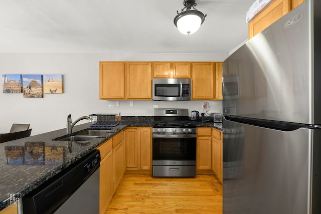 525 W Washington Ave Unit 6, Lake Bluff, IL 60044 - kitchen with appliances with stainless steel finishes, light wood-type flooring, dark stone counters, and a peninsula
