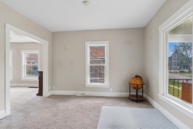 458 Douglas St, Joliet, IL 60435 - carpeted empty room with healthy amount of natural light and a smoke detector
