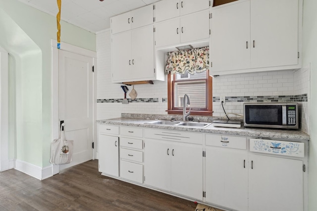 458 Douglas St, Joliet, IL 60435 - kitchen featuring stainless steel microwave, tasteful backsplash, light countertops, and white cabinetry