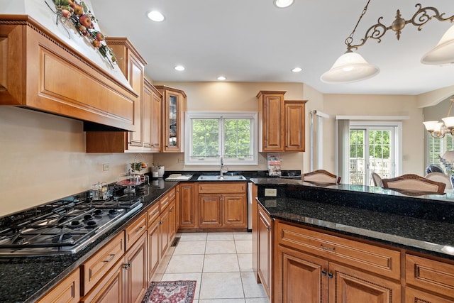 13738 Legend Trail Ln, Orland Park, IL 60462 - kitchen with a sink, brown cabinetry, gas stovetop, dark stone counters, and hanging light fixtures