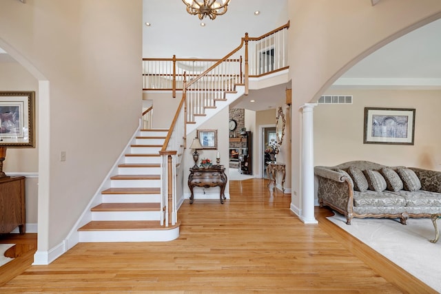 13738 Legend Trail Ln, Orland Park, IL 60462 - foyer with light wood-style floors, a high ceiling, arched walkways, stairway, and baseboards