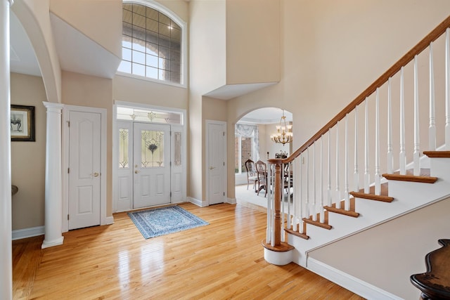 13738 Legend Trail Ln, Orland Park, IL 60462 - entryway with arched walkways, a high ceiling, healthy amount of natural light, wood finished floors, and a chandelier
