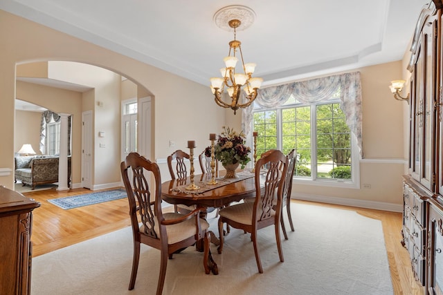 13738 Legend Trail Ln, Orland Park, IL 60462 - dining space with a chandelier, arched walkways, light wood-style flooring, and baseboards