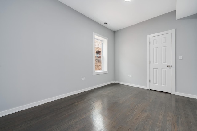 7925 S May St, Chicago, IL 60620 - spare room with dark wood-style floors and baseboards