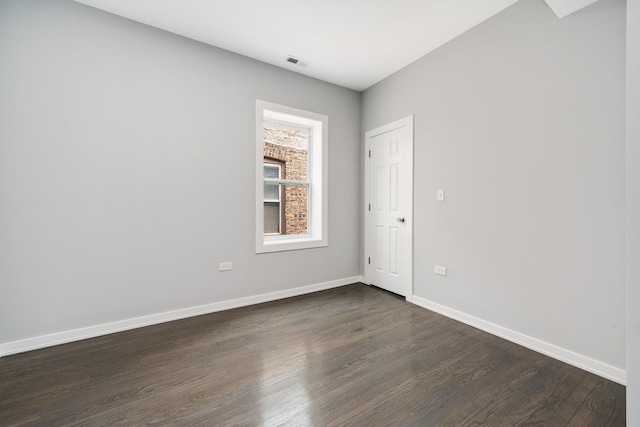 7925 S May St, Chicago, IL 60620 - spare room featuring dark wood-style floors and baseboards