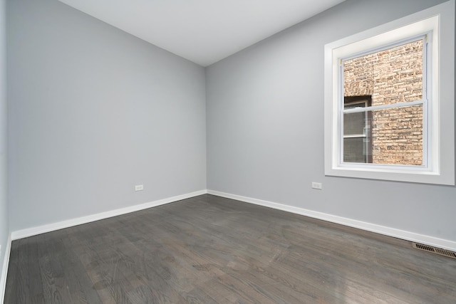 7925 S May St, Chicago, IL 60620 - unfurnished room featuring dark wood-type flooring and baseboards