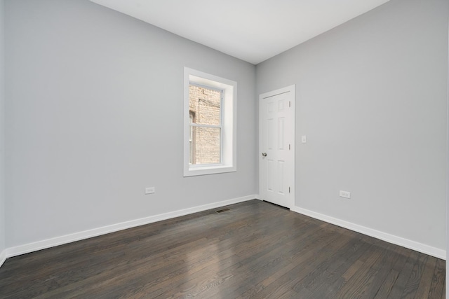 7925 S May St, Chicago, IL 60620 - unfurnished room with dark wood-style flooring and baseboards