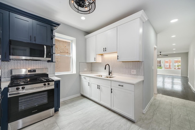 7925 S May St, Chicago, IL 60620 - kitchen with appliances with stainless steel finishes, a sink, light countertops, ceiling fan, and tasteful backsplash