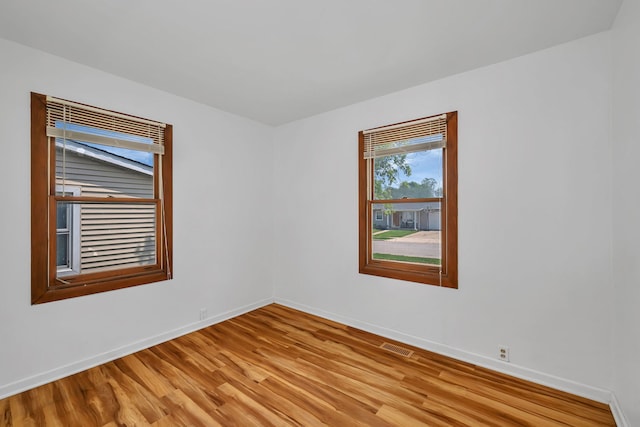402 Kenyon Ave, Romeoville, IL 60446 - unfurnished room with light wood finished floors and baseboards
