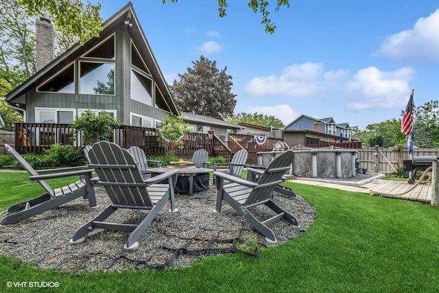 610 Mchenry Ave, Mchenry, IL 60050 - rear view of property with a fire pit, a chimney, and a wooden deck