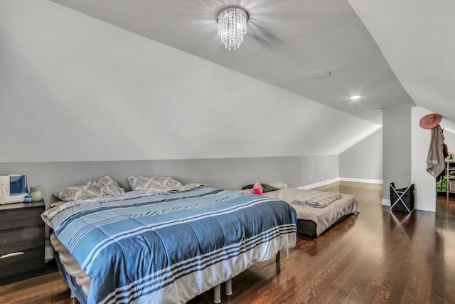1313 W Cornelia Ave, Waukegan, IL 60085 - bedroom with lofted ceiling, wood finished floors, baseboards, and a chandelier
