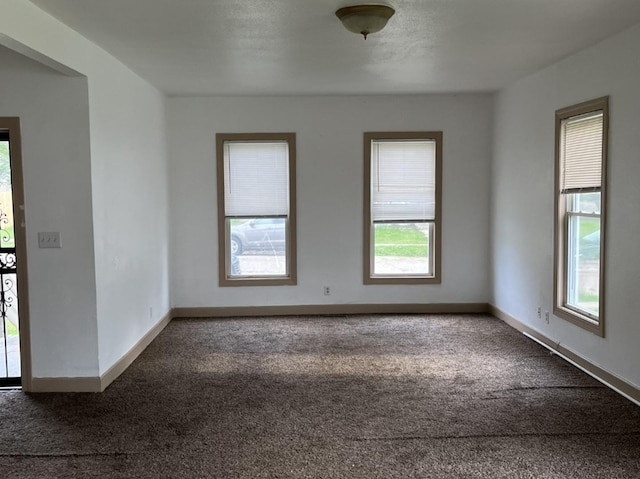 110-112 E Frank St, Freeport, IL 61032 - spare room featuring dark colored carpet and baseboards