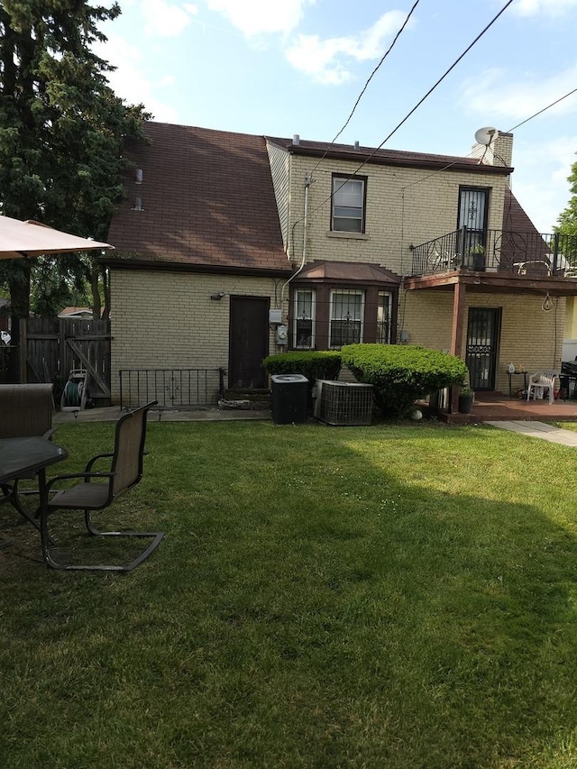 46 E 155th St, Harvey, IL 60426 - rear view of property with brick siding and a balcony