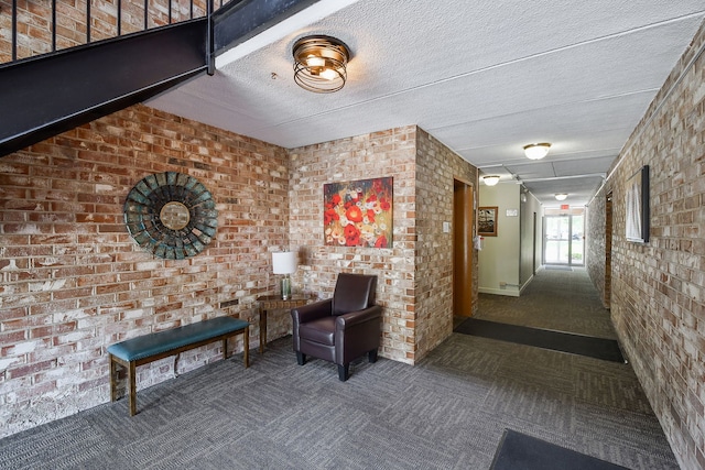 100 W Park Cir Unit 1E, Wheaton, IL 60187 - hall with carpet flooring, brick wall, and a textured ceiling