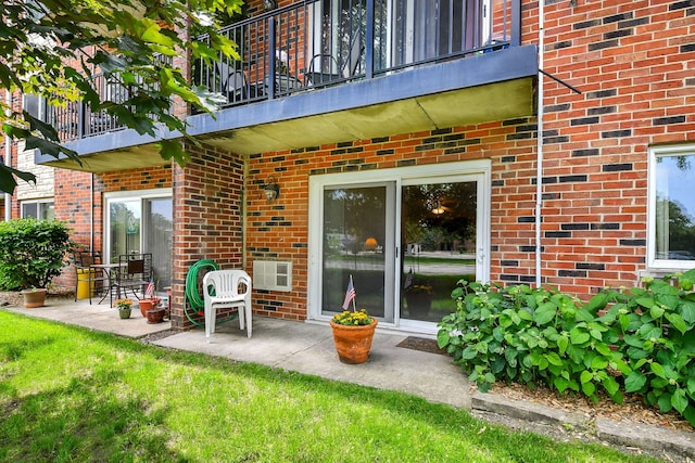 100 W Park Cir Unit 1E, Wheaton, IL 60187 - rear view of property featuring a balcony, brick siding, a patio, and a yard