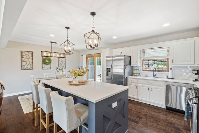 5907 W 124th St, Alsip, IL 60803 - kitchen with stainless steel appliances, a chandelier, recessed lighting, a center island, and white cabinetry
