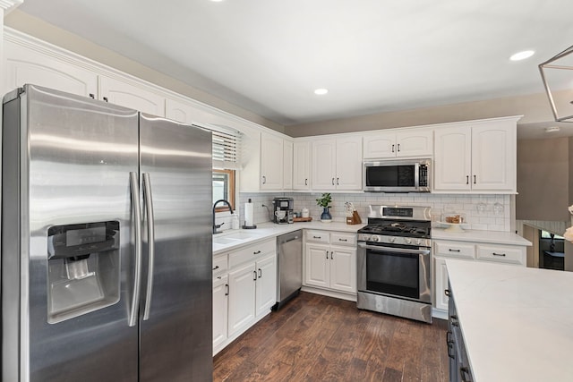 5907 W 124th St, Alsip, IL 60803 - kitchen with stainless steel appliances, dark wood-style flooring, white cabinets, light countertops, and tasteful backsplash