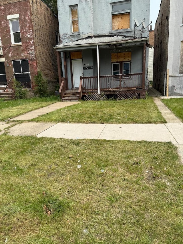 11745 S Union Ave, Chicago, IL 60628 - view of front facade featuring a porch, brick siding, and a front lawn