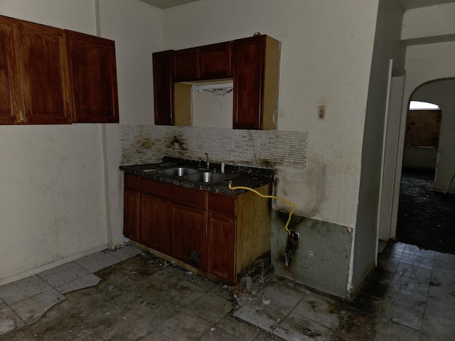 11745 S Union Ave, Chicago, IL 60628 - kitchen featuring arched walkways, a sink, and backsplash