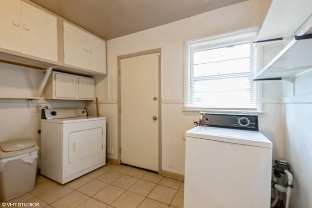 14841 Langley Ave, Dolton, IL 60419 - washroom featuring washer / clothes dryer, cabinet space, and light tile patterned floors