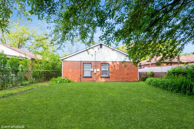 14841 Langley Ave, Dolton, IL 60419 - rear view of house with a fenced backyard and brick siding